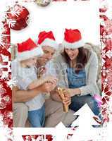Happy parents with son opening crackers together