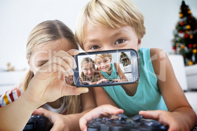 Composite image of hand holding smartphone showing