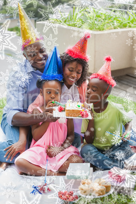 Family celebrating a birthday together in the garden