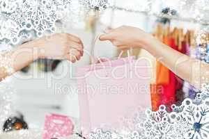 Saleswoman giving a shopping bag to a customer