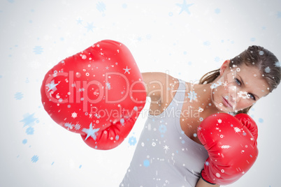 Composite image of serious woman boxing