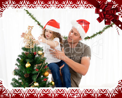 Cute daughter decorating the christmas tree with his father