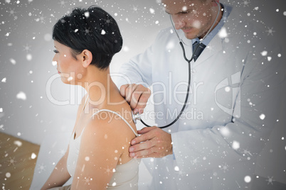 Composite image of doctor using stethoscope on back of patient