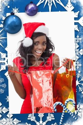 Composite image of woman holding bags while smiling