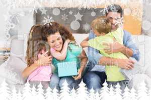 Composite image of young siblings giving presents to their paren