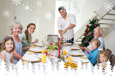 Composite image of family having christmas meal at dining table