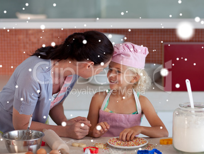 Composite image of nice mother and her daughter baking in a kitc