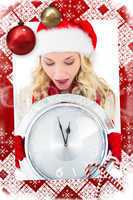 Festive blonde holding large clock