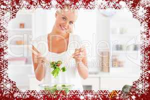 Composite image of cute woman mixing a salad