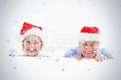 Festive mature couple smiling at camera