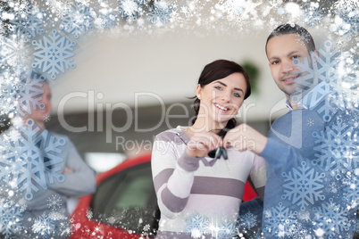 Composite image of car dealer giving keys to a customer