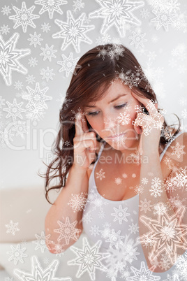 Attractive brunette woman having a headache while sitting