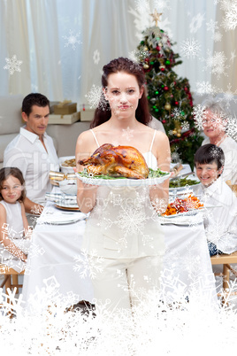 Composite image of mother showing turkey for christmas dinner