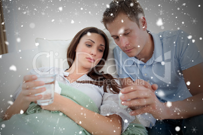 Composite image of caring man nursing his sick wife