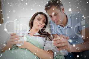 Composite image of caring man nursing his sick wife