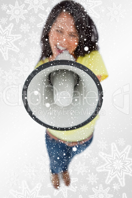 Composite image of close up of a megaphone holding by a young wo