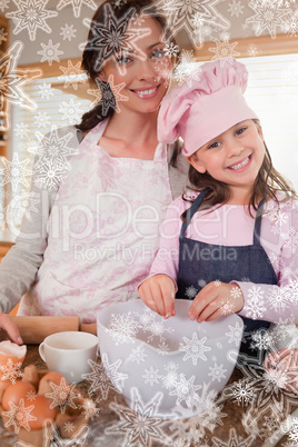 Portrait of a mother baking with her daughter