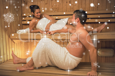Calm couple relaxing in a sauna and chatting