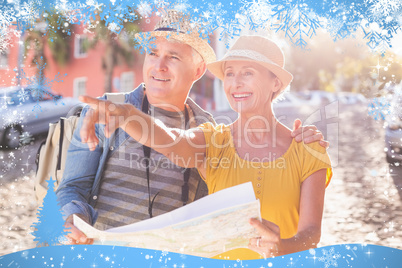 Happy tourist couple using map in the city