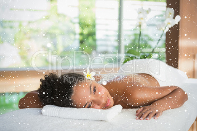 Gorgeous woman lying on massage table with salt treatment on back