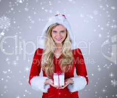 Composite image of pretty girl in santa outfit holding gift