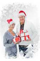 Composite image of festive mature couple in winter clothes holdi