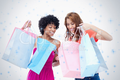 Teenage girls looking at each others purchases