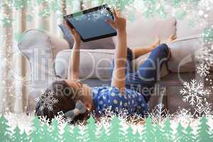Little girl using digital tablet in the living room