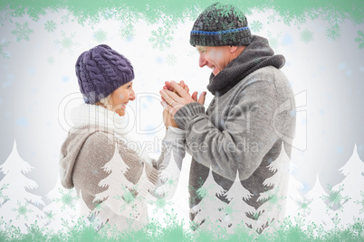 Happy mature couple in winter clothes embracing