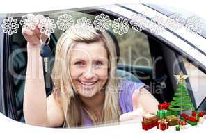 Charming female driver showing a key after bying a new car