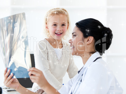 Composite image of caring female doctor showing an xray to a lit