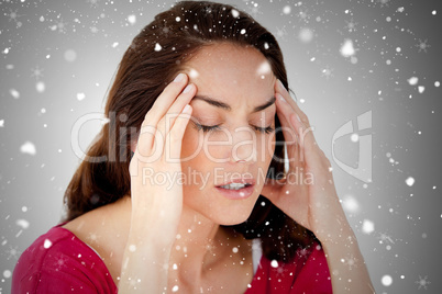 Composite image of beautiful woman having a headache