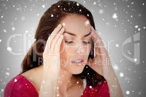 Composite image of beautiful woman having a headache