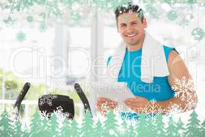 Smiling trainer with clipboard in gym