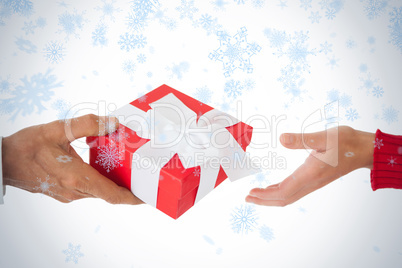 Couple passing a wrapped gift