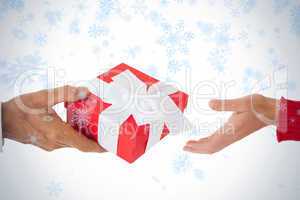 Couple passing a wrapped gift