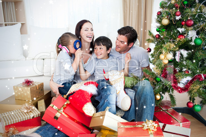 Happy family playing with christmas gifts