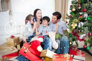 Happy family playing with christmas gifts
