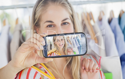 Composite image of hand holding smartphone showing