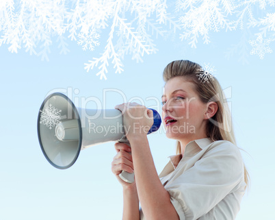 Blonde businesswoman shouting through megaphone