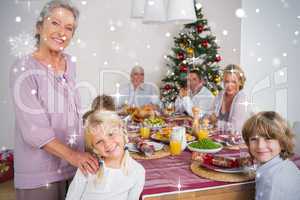 Composite image of grandmother and granddaughter standing beside