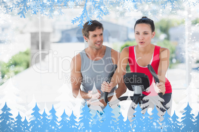 Woman with male instructor working out at spinning class