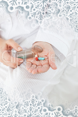 Sick woman taking her pills at home