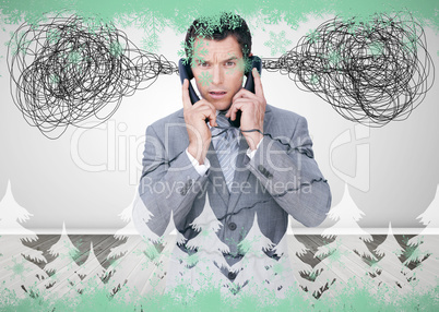 Overworked businessman holding two telephones