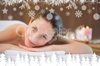 Beautiful woman lying on massage table at spa center