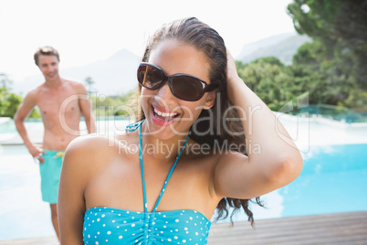 Beautiful woman by swimming pool on a sunny day