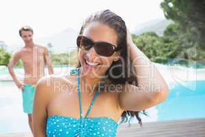 Beautiful woman by swimming pool on a sunny day