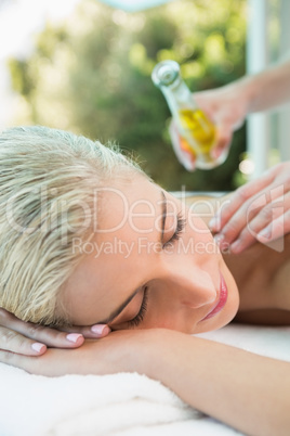 Attractive woman receiving back massage at spa center