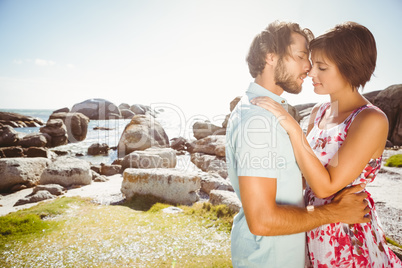 Gorgeous couple embracing by the coast