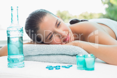 Woman lying on massage table at spa center